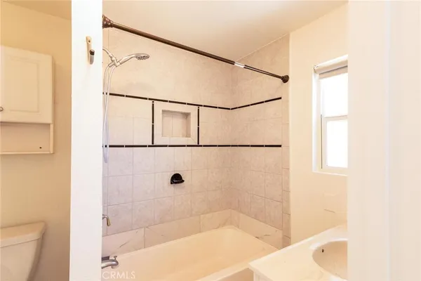 a bathroom with a sink a mirror and a shower