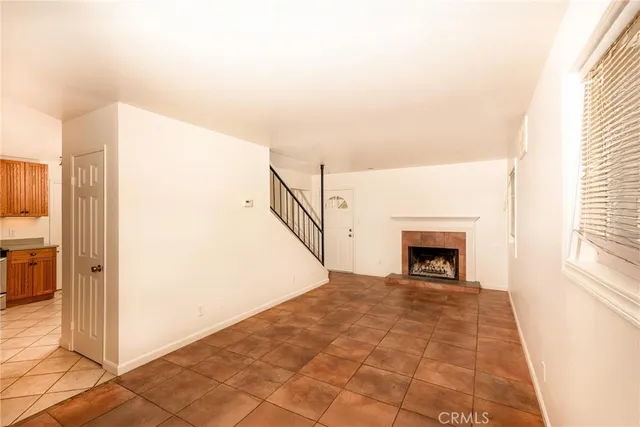 a view of a livingroom with an empty space and a fireplace