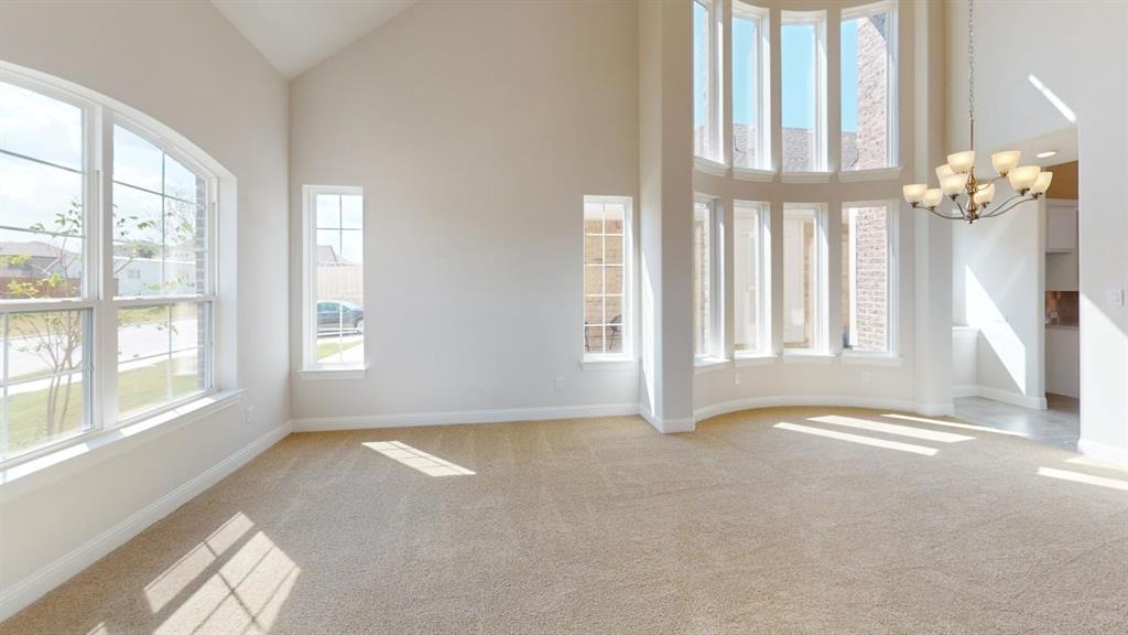 8407 Cornerstone Drive Rowlett, TX 75088 - Photo 22 of 25 Expansive interior space featuring a double-height ceiling, large arched window, and a multi-pane curved window wall