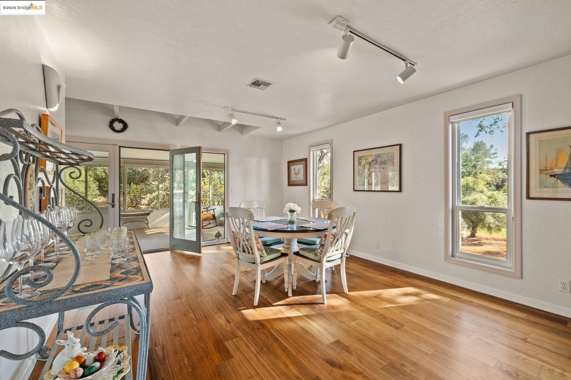 10566 Thistle Down Road Jamestown, CA 95327 - Photo 12 of 53 Dining space featuring rail lighting and light wood-type flooring