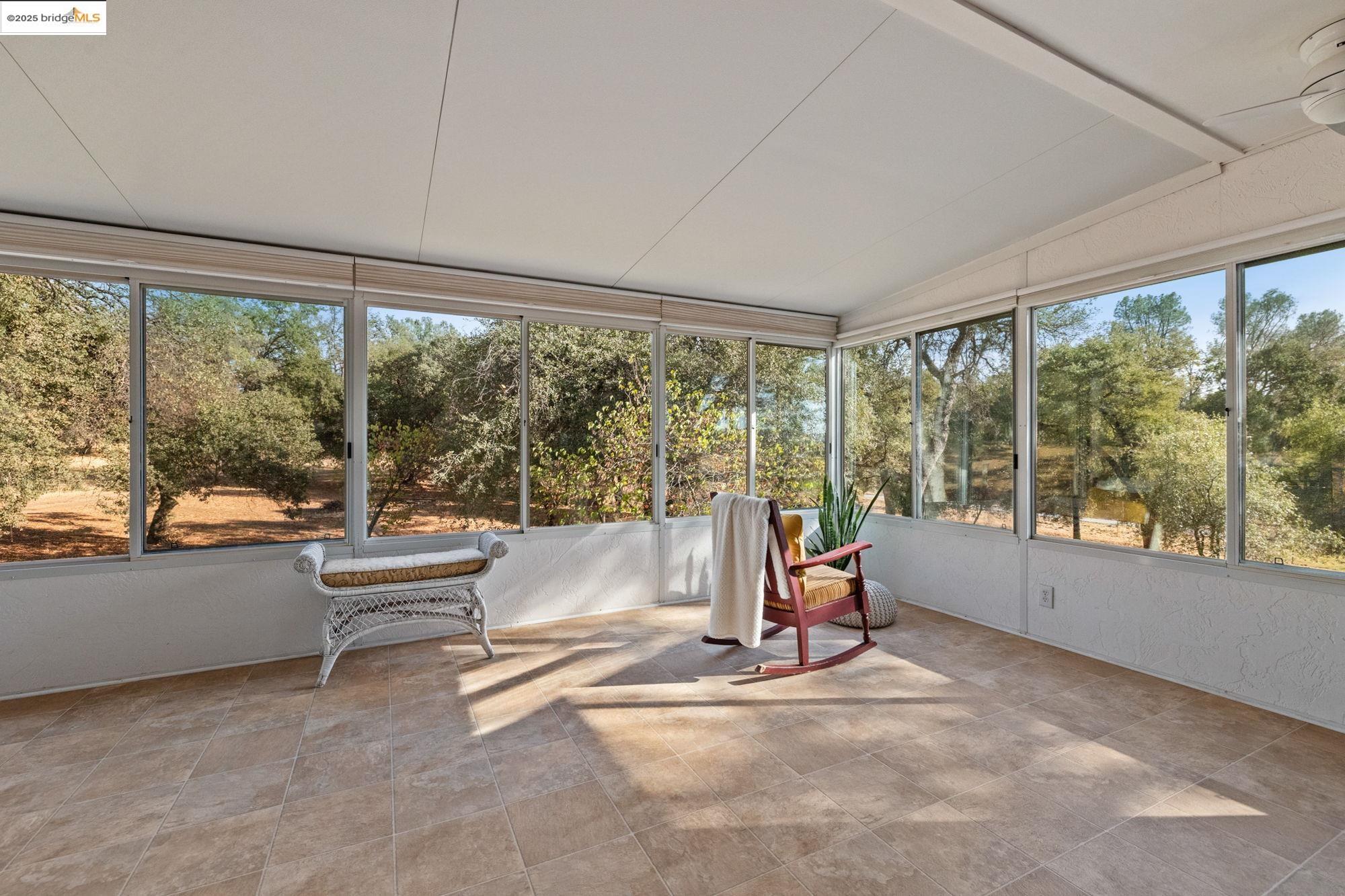 10566 Thistle Down Road Jamestown, CA 95327 - Photo 20 of 53 Sunroom / solarium featuring lofted ceiling and view of scattered trees