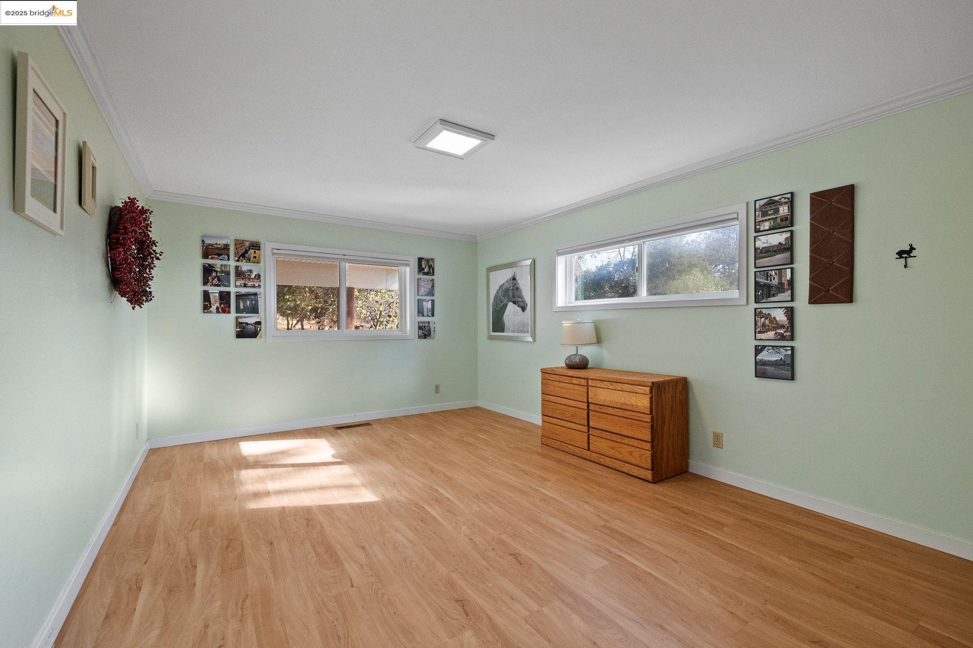 10566 Thistle Down Road Jamestown, CA 95327 - Photo 30 of 53 Unfurnished bedroom featuring ornamental molding and light wood-type flooring