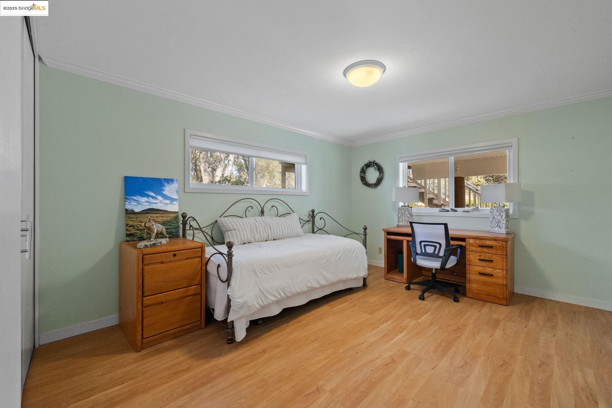 10566 Thistle Down Road Jamestown, CA 95327 - Photo 31 of 53 Bedroom with ornamental molding, light wood-style flooring, and an office area