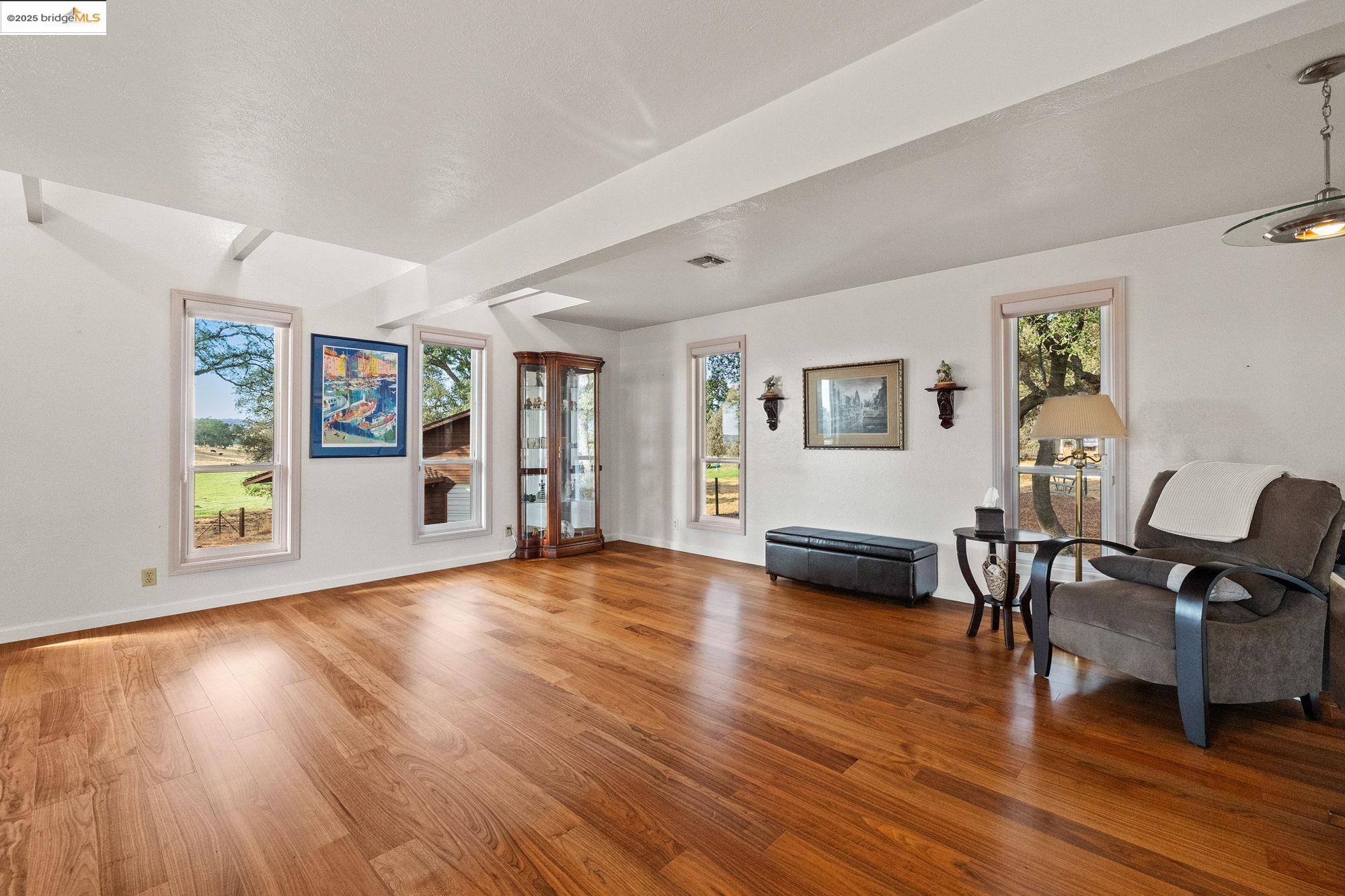 10566 Thistle Down Road Jamestown, CA 95327 - Photo 8 of 53 Living area with wood finished floors and baseboards