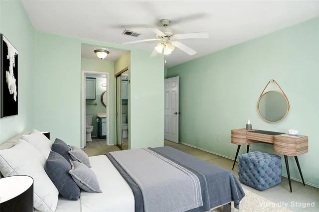 a bedroom with a bed a chandelier and a mirror