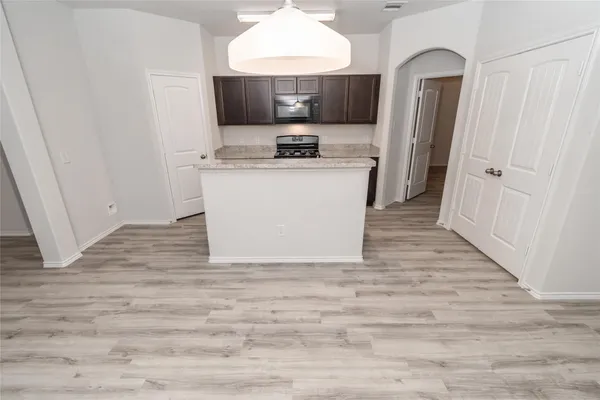 a view of a kitchen from the hallway