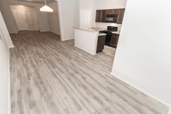 a view of a room with wooden floor