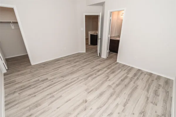 a view of room with wooden floor