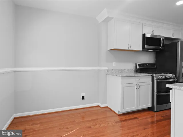 a kitchen with stainless steel appliances a refrigerator and cabinets