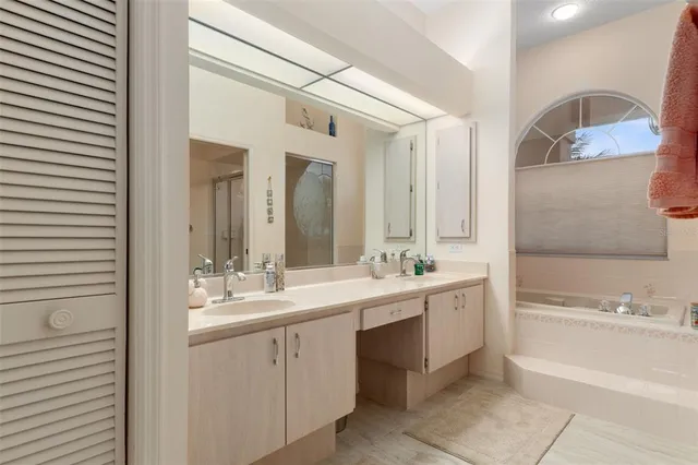 a bathroom with a granite countertop sink a toilet a mirror and shower
