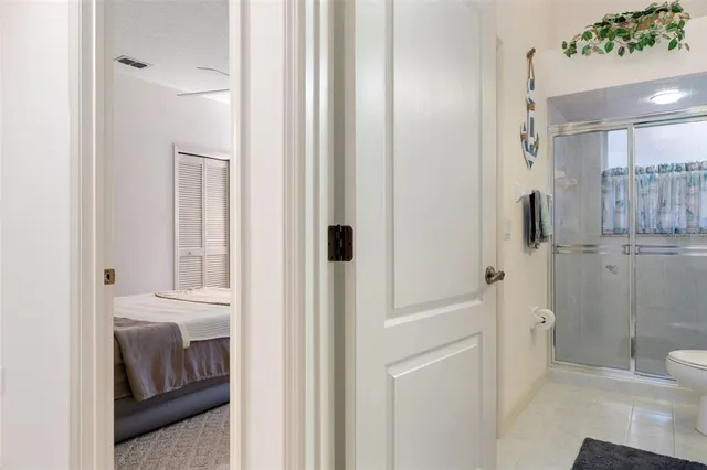 a dining room with furniture and a floor to ceiling window
