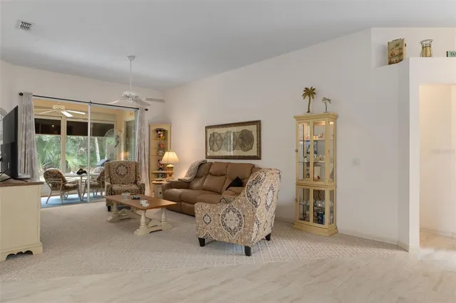 a bedroom with furniture and a large window