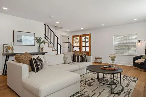 a living room with furniture and a table