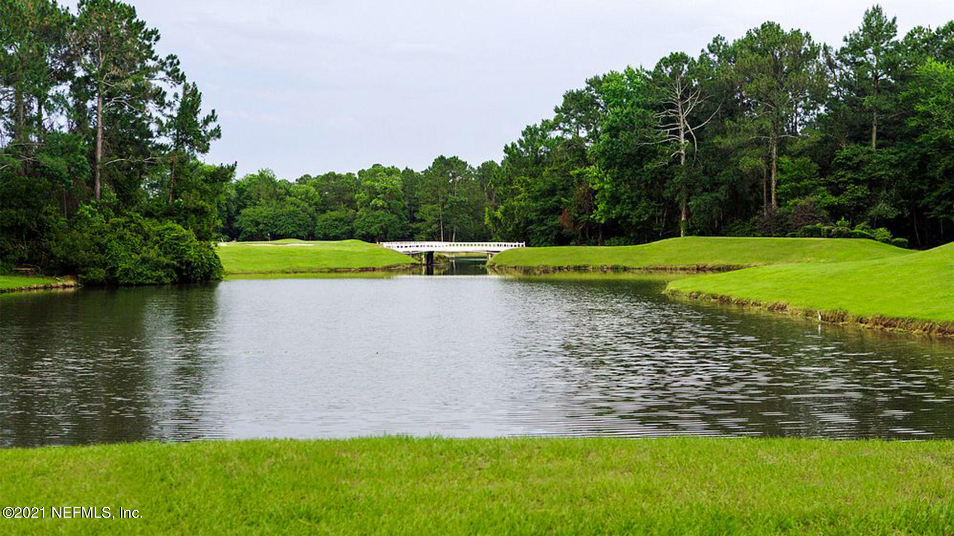 3438 Lawton Road Orlando, FL 32803 - Photo 4 of 10 a view of a lake with a yard and large trees