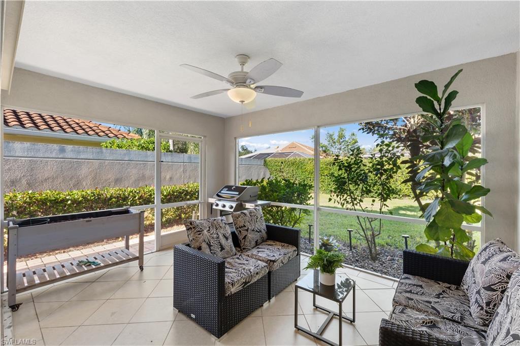 3238 Barbados Lane Naples, FL 34119 - Photo 23 of 43 a outdoor living space with furniture potted plant and a floor to ceiling window