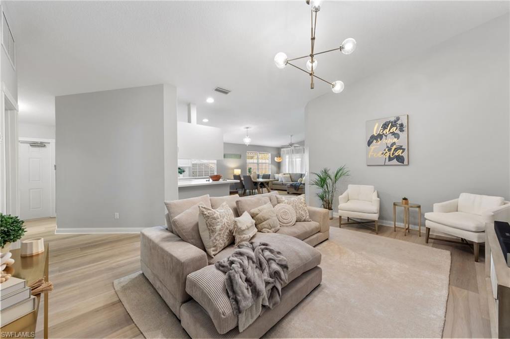 3238 Barbados Lane Naples, FL 34119 - Photo 10 of 43 a living room with furniture and a chandelier