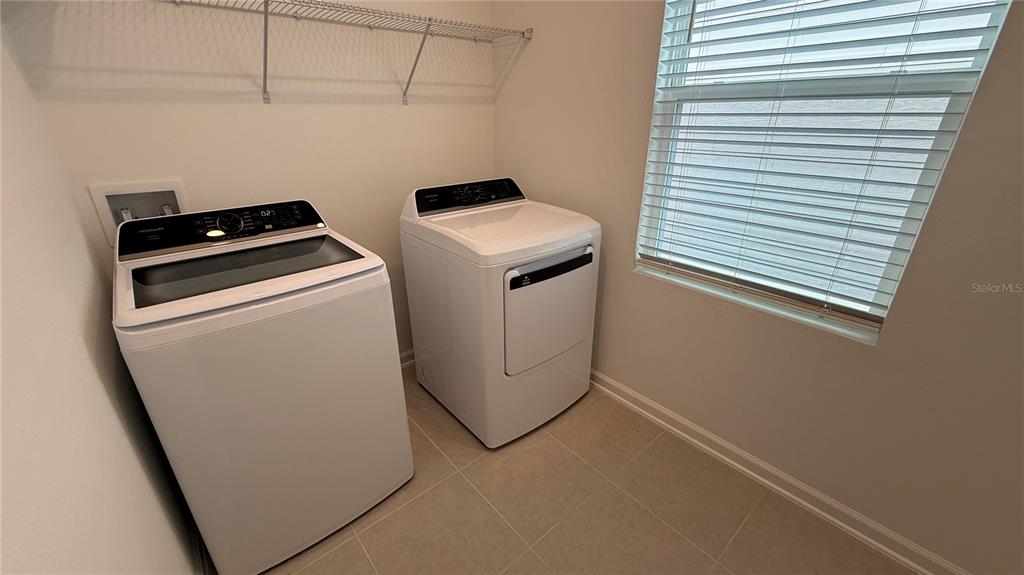 6045 Wellbeing Way Clermont, FL 34714 - Photo 15 of 19 a utility room with dryer and washer