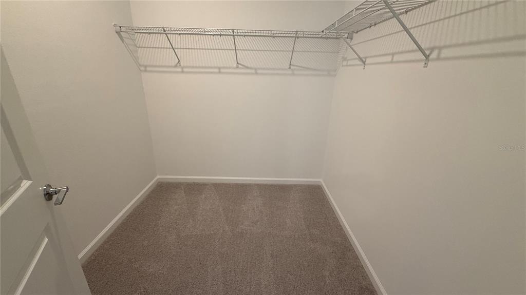 6045 Wellbeing Way Clermont, FL 34714 - Photo 19 of 19 a view of a room with racks on the wall