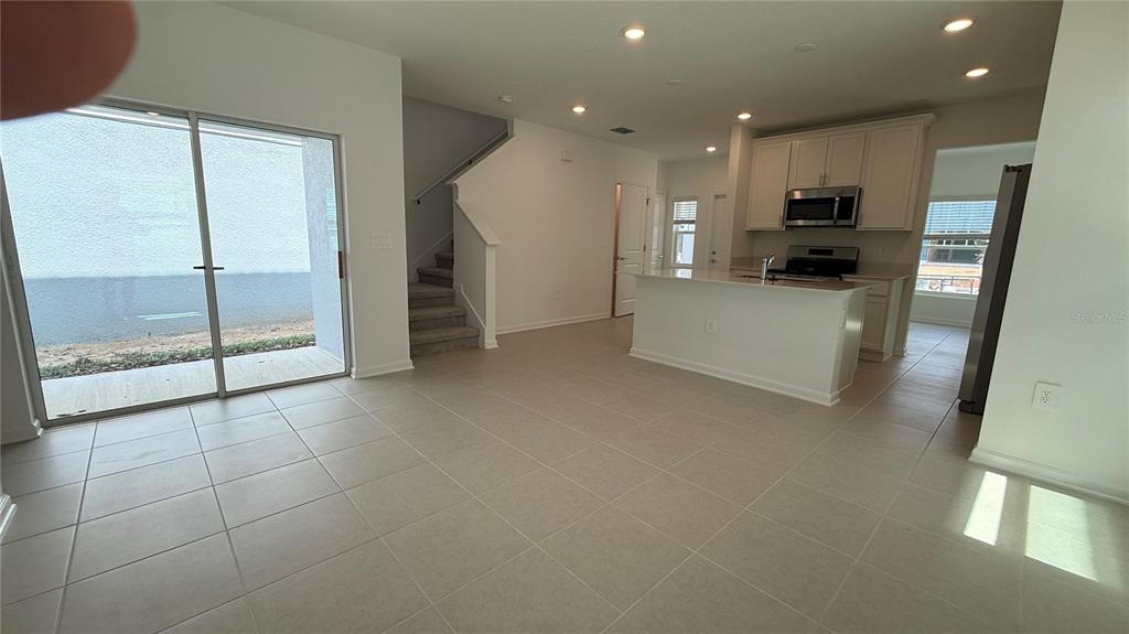 6045 Wellbeing Way Clermont, FL 34714 - Photo 6 of 19 a view of kitchen with refrigerator sink and wooden floor