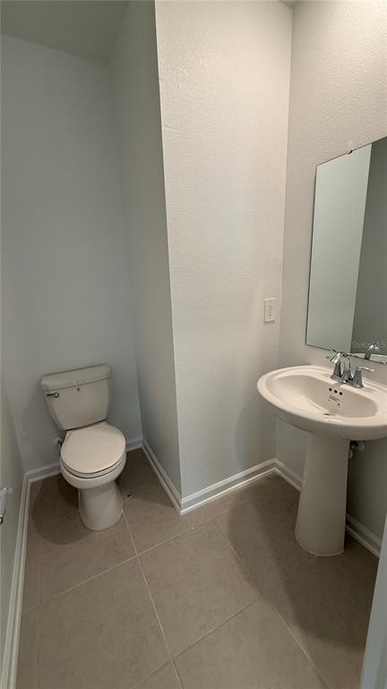 6045 Wellbeing Way Clermont, FL 34714 - Photo 7 of 19 a bathroom with a toilet a sink and a window