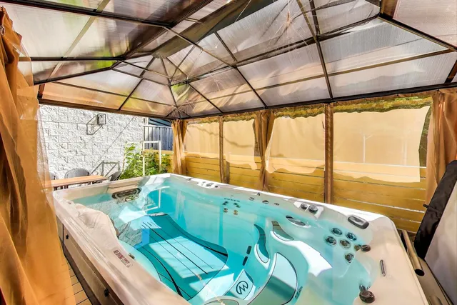 a kitchen with kitchen island a sink a stove a refrigerator and a dining table with wooden floor