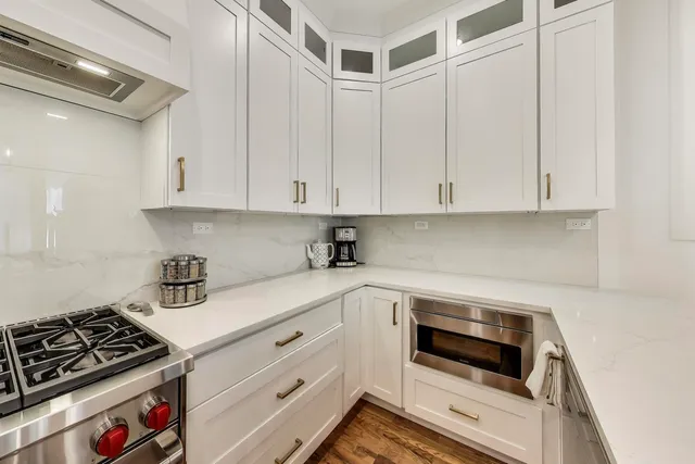 a dining room with furniture a chandelier and wooden floor