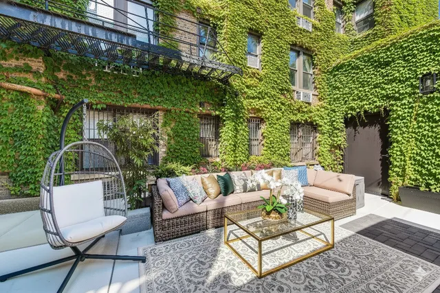 a view of a patio with couches table and chairs and potted plants