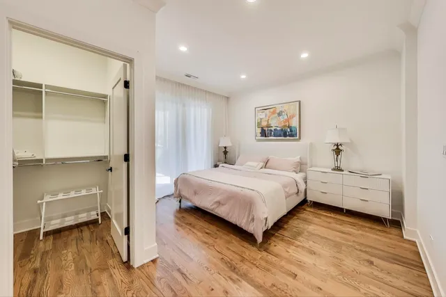 a bathroom with a double vanity sink toilet mirror and shower
