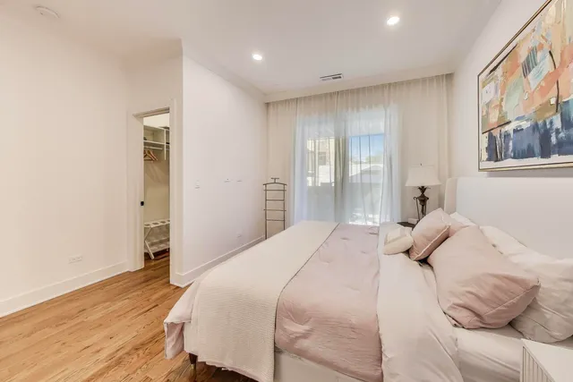 a bathroom with a bathtub shower sink vanity and mirror