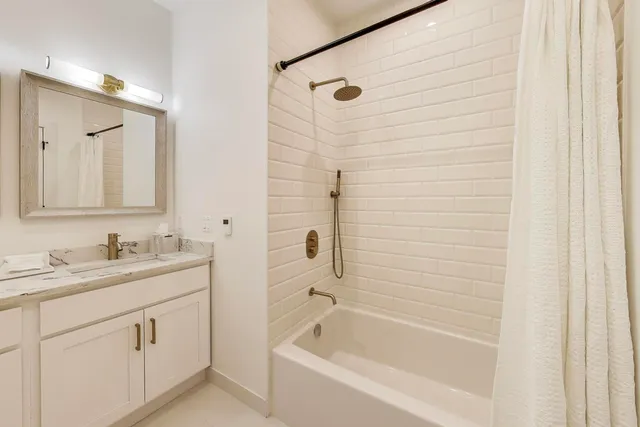 a bedroom with a bed and a potted plant on the dresser
