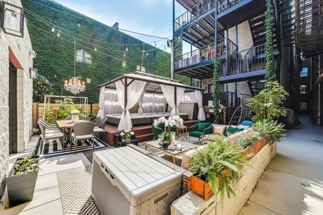 a view of a chairs and table in patio with a barbeque grill