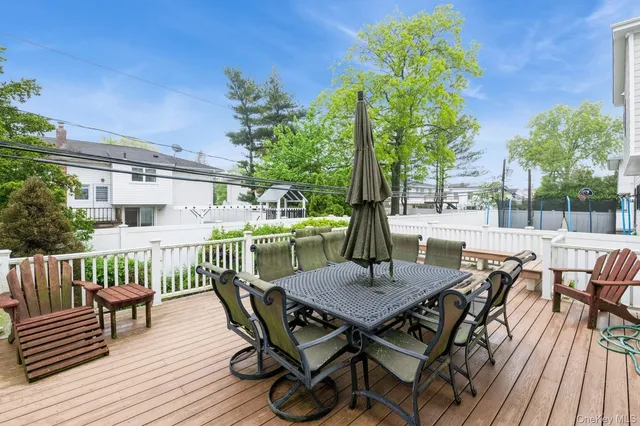 a view of a dinning table and chairs in patio of the house