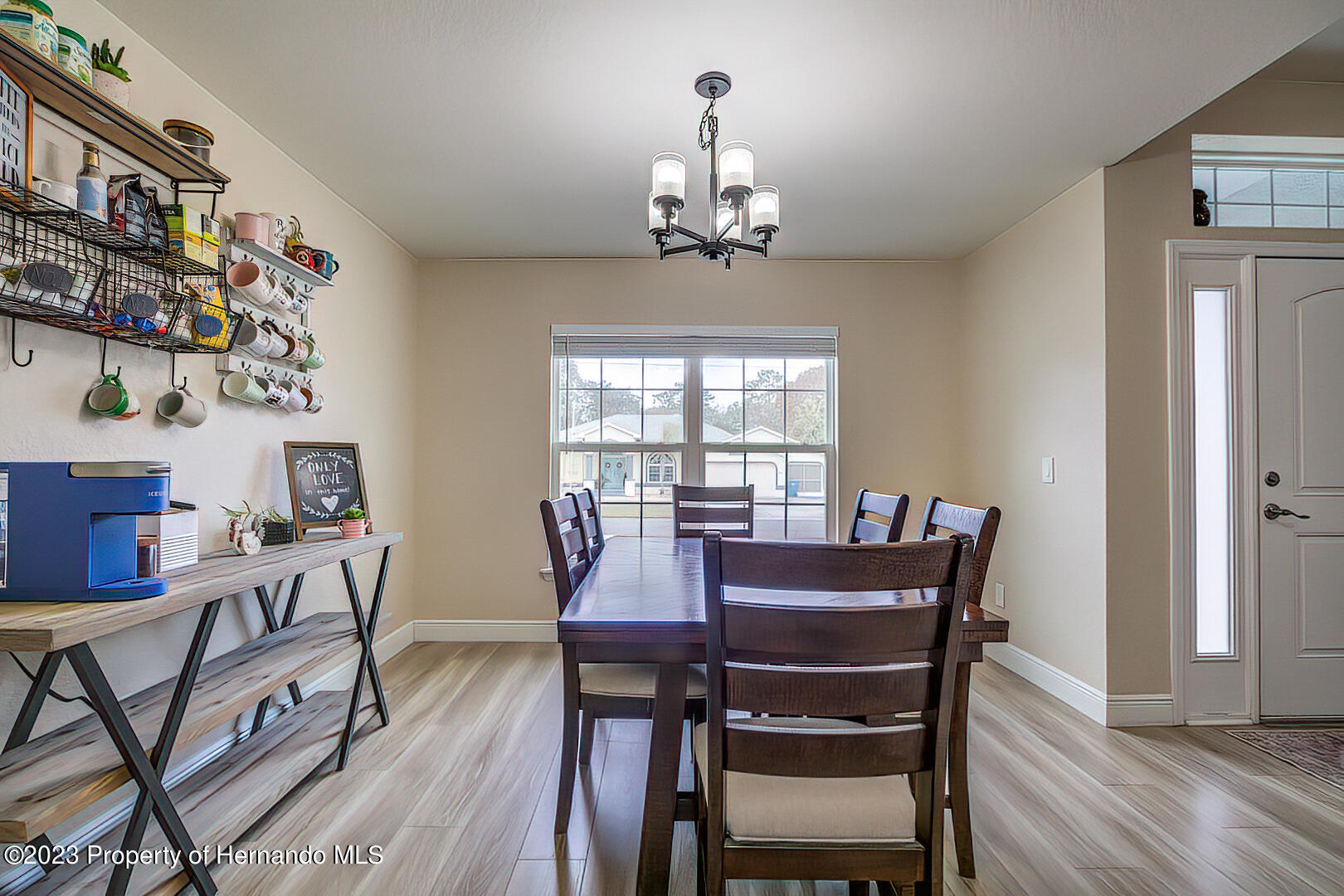 8140 Jasbow Junction Weeki Wachee, FL 34613 - Photo 11 of 37 a view of a dining room with furniture window and wooden floor