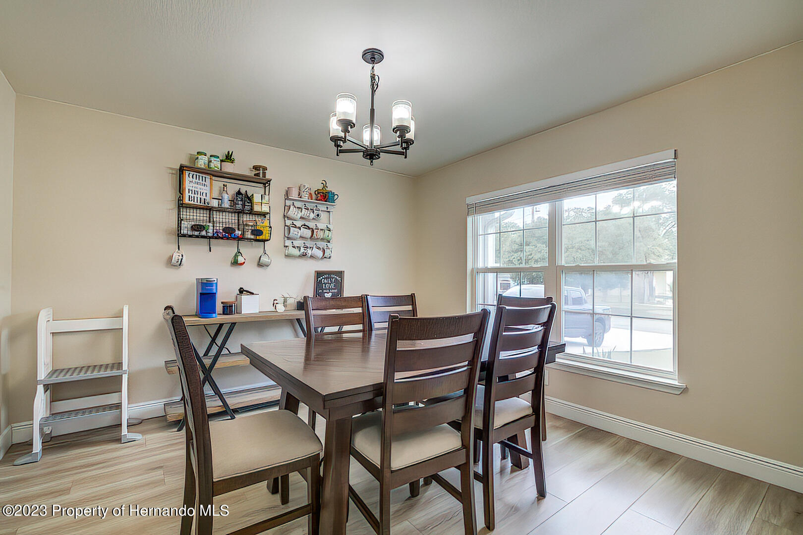 8140 Jasbow Junction Weeki Wachee, FL 34613 - Photo 12 of 37 a view of a dining room with furniture wooden floor and chandelier