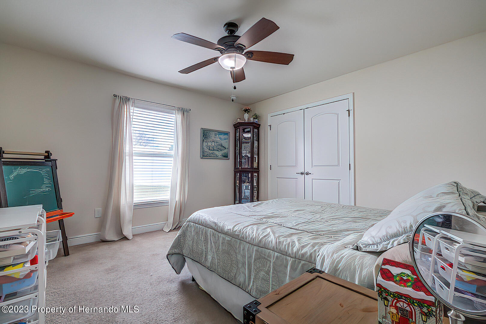 8140 Jasbow Junction Weeki Wachee, FL 34613 - Photo 17 of 37 a bedroom with a bed and a window