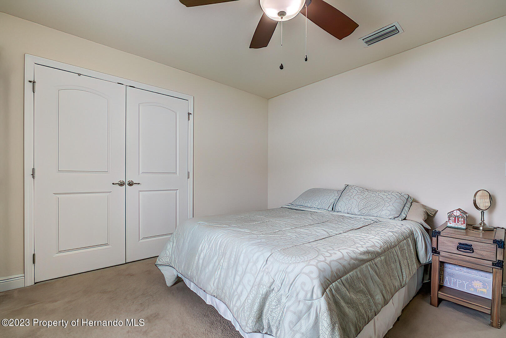 8140 Jasbow Junction Weeki Wachee, FL 34613 - Photo 18 of 37 a bedroom with a bed and a chandelier