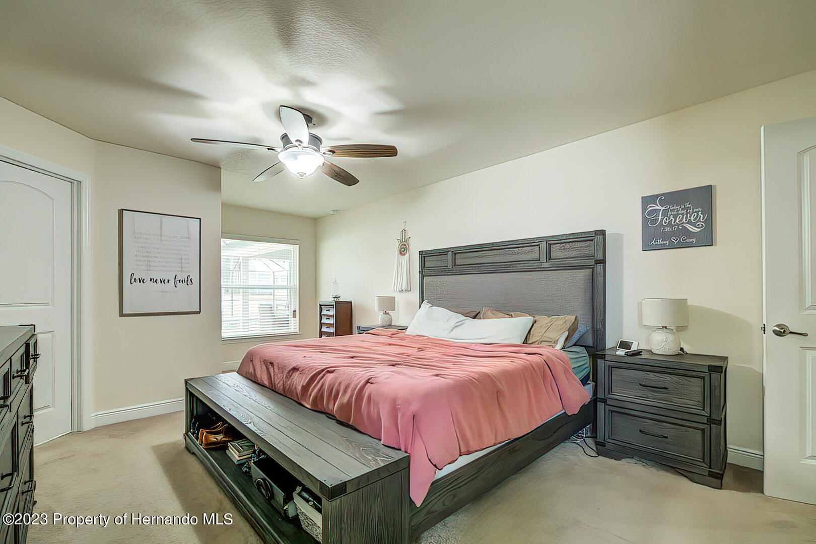 8140 Jasbow Junction Weeki Wachee, FL 34613 - Photo 23 of 37 a bedroom with a bed chandelier and a window
