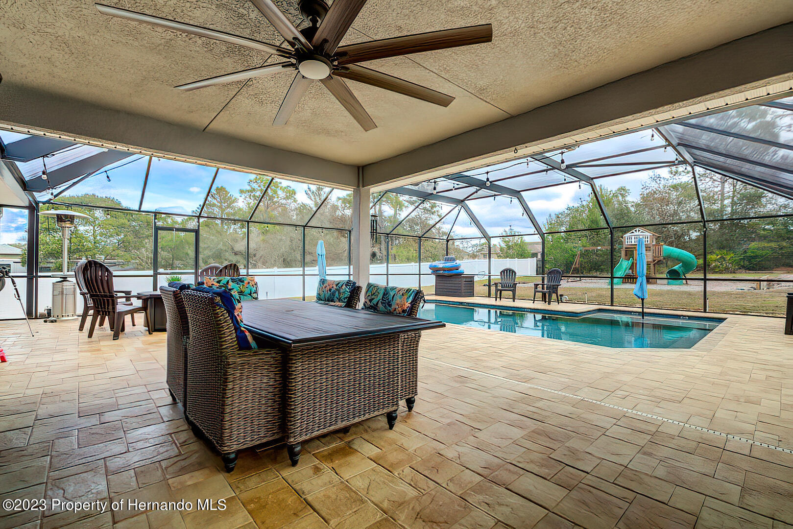 8140 Jasbow Junction Weeki Wachee, FL 34613 - Photo 26 of 37 a view of a patio with a table and chairs