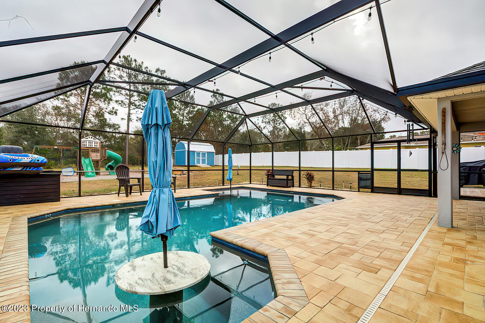 8140 Jasbow Junction Weeki Wachee, FL 34613 - Photo 28 of 37 a view of a swimming pool with a patio