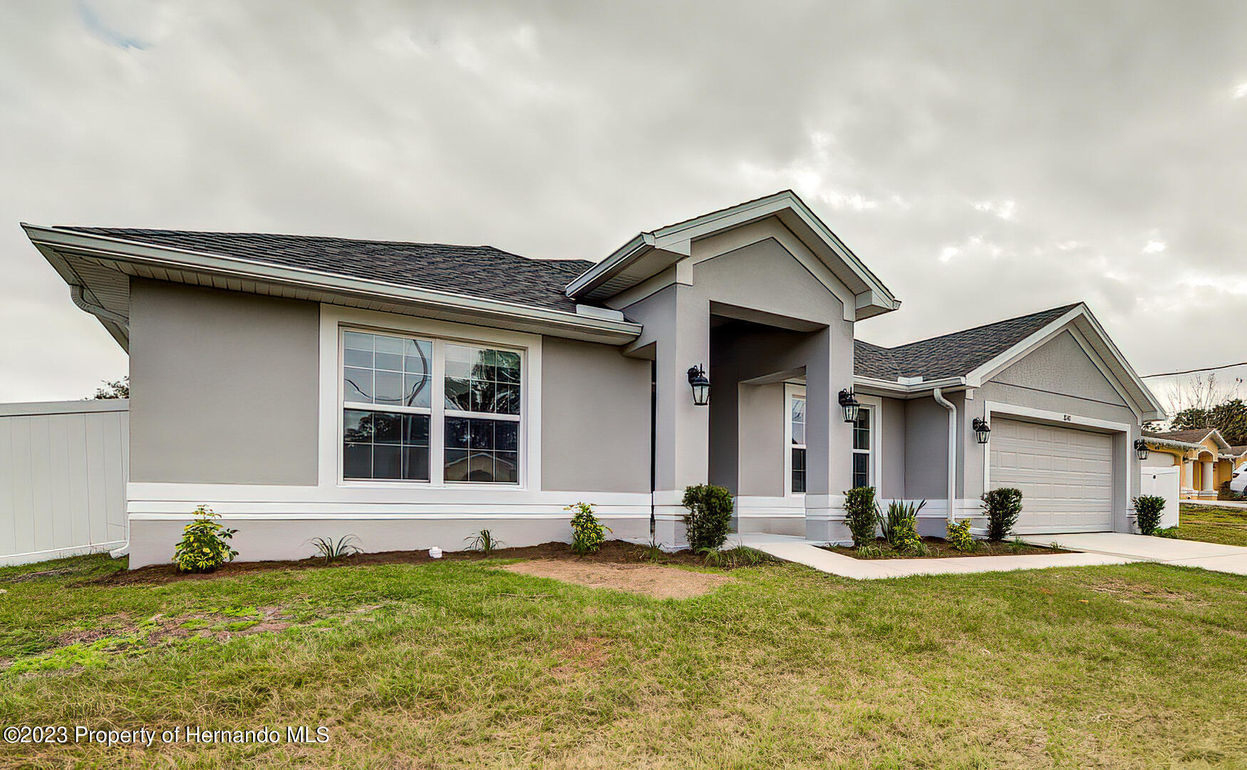 8140 Jasbow Junction Weeki Wachee, FL 34613 - Photo 3 of 37 a front view of a house with a yard