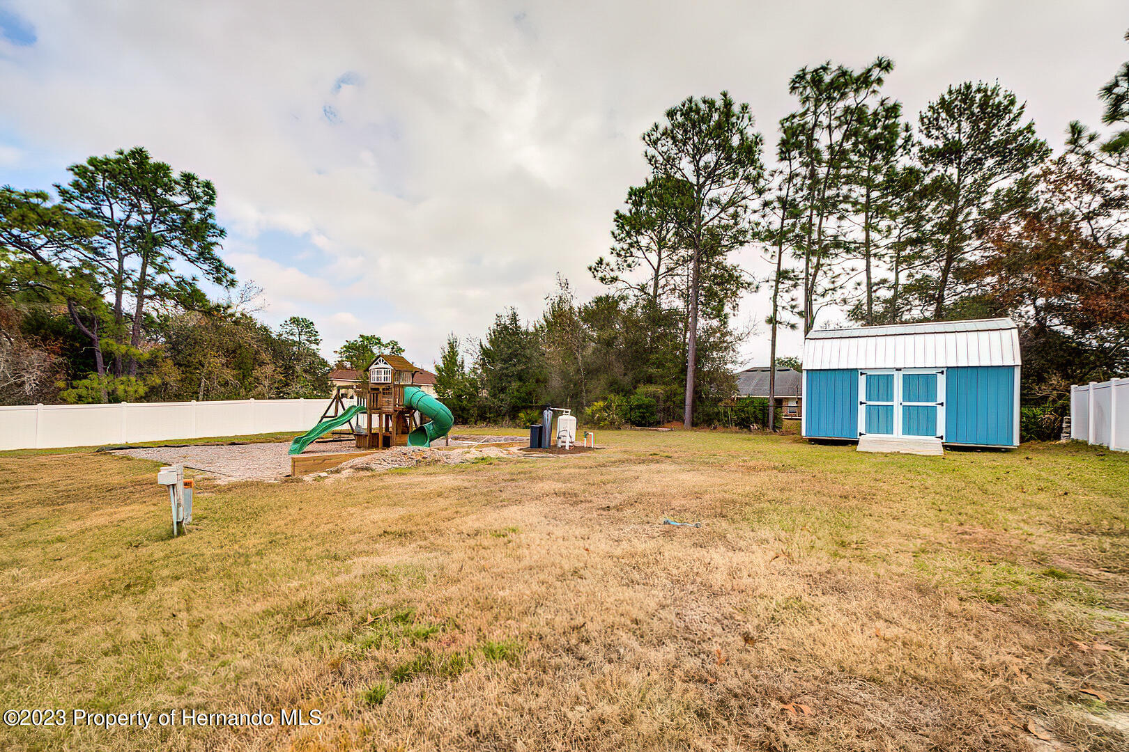 8140 Jasbow Junction Weeki Wachee, FL 34613 - Photo 32 of 37 a view of a house with backyard and trees