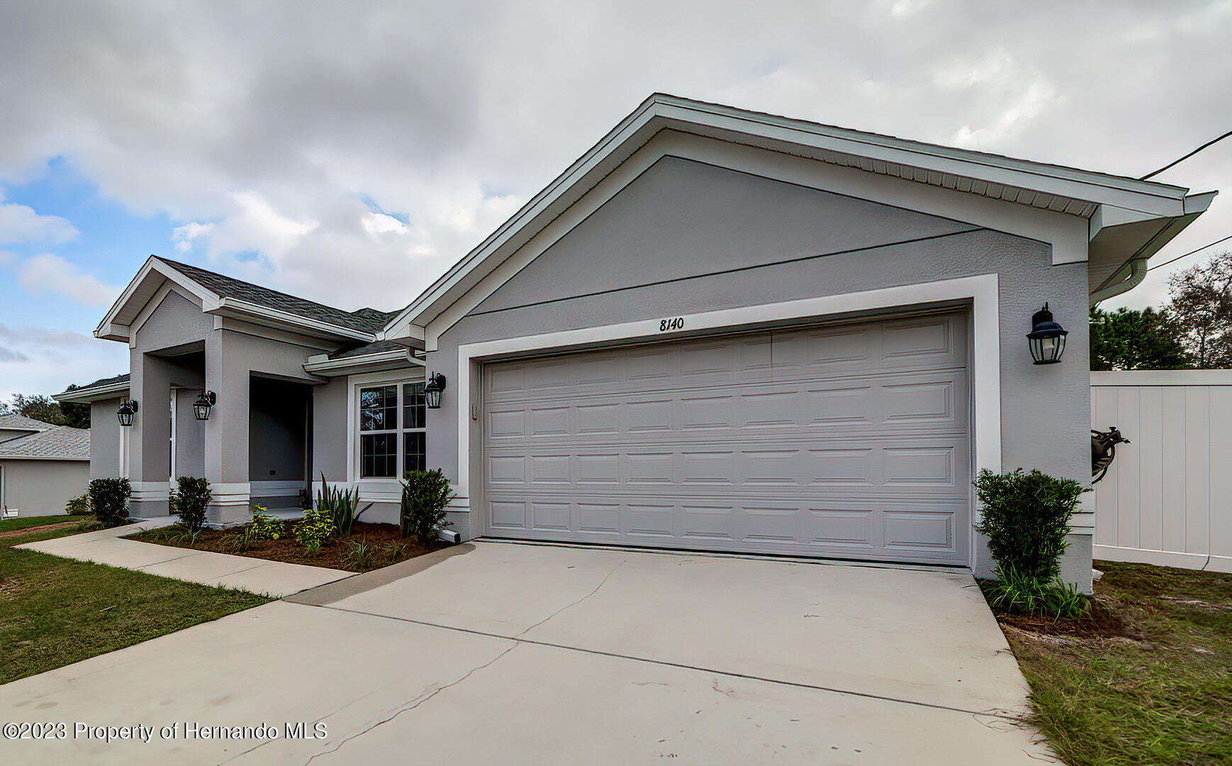 8140 Jasbow Junction Weeki Wachee, FL 34613 - Photo 4 of 37 a front view of a house with garage