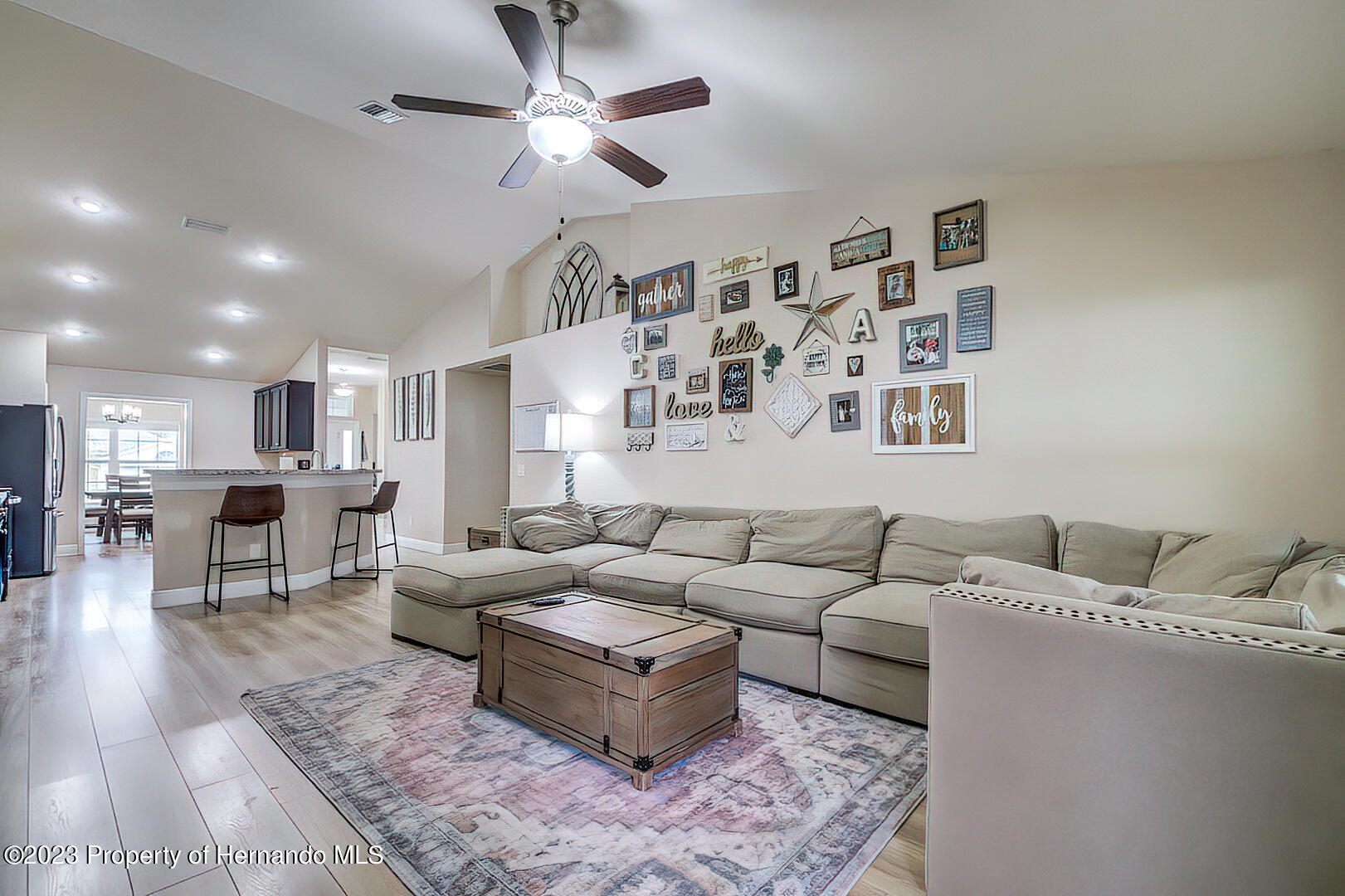 8140 Jasbow Junction Weeki Wachee, FL 34613 - Photo 6 of 37 a living room with furniture kitchen view and a table