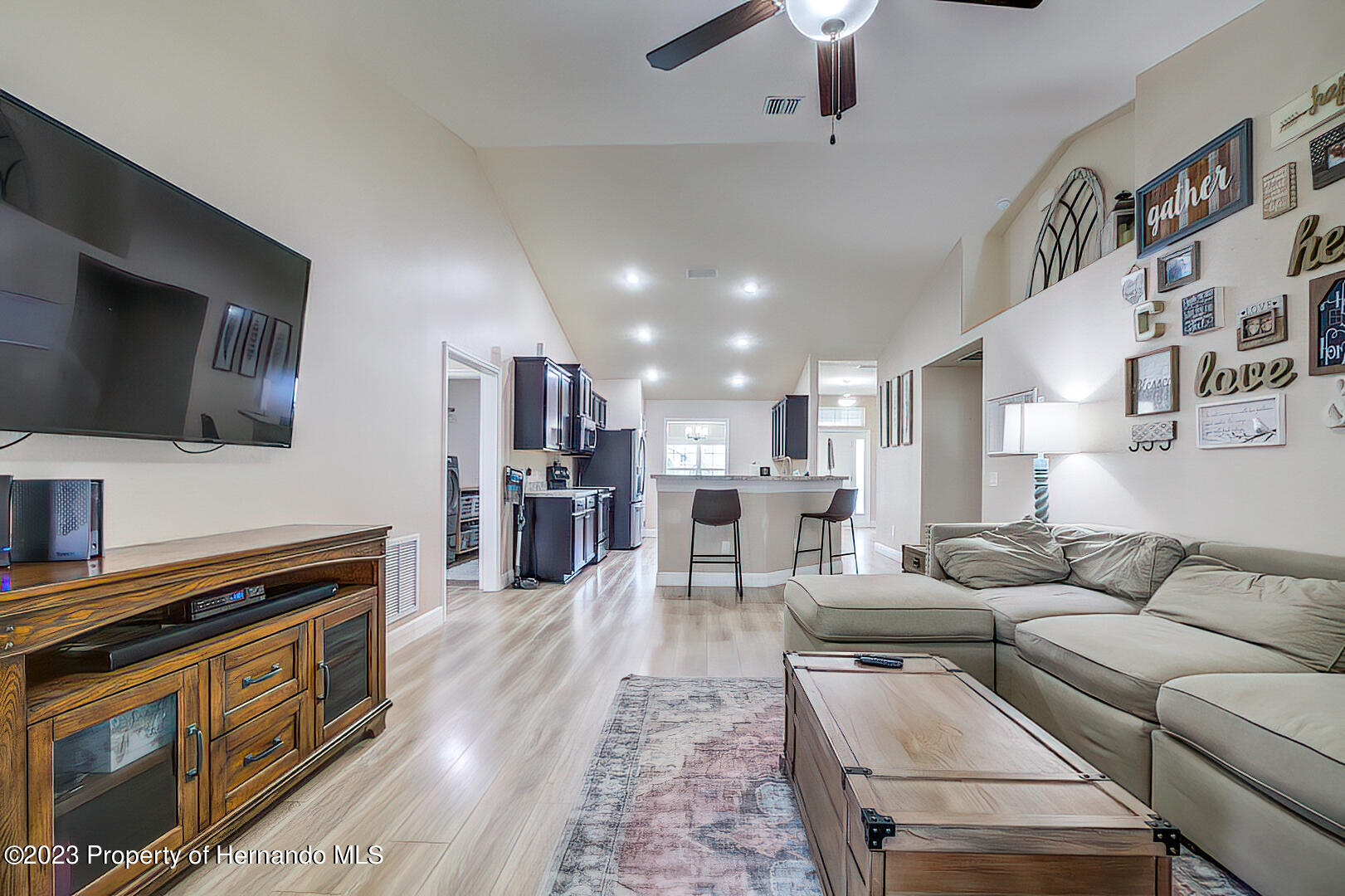 8140 Jasbow Junction Weeki Wachee, FL 34613 - Photo 7 of 37 a living room with furniture and a flat screen tv