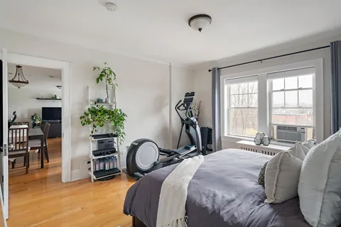 a bedroom with furniture and a large window