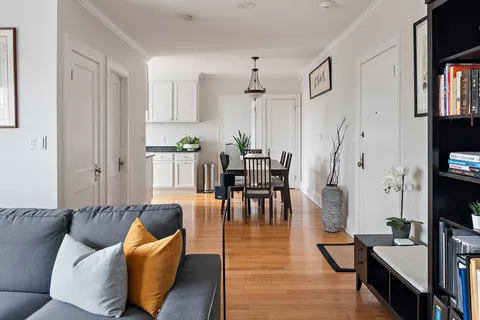 a living room with furniture wooden floor and a flat screen tv