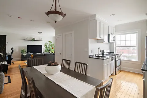 a view of a dining room with furniture window and wooden floor