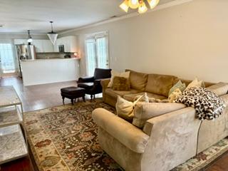 106 Antique Court Pendleton, SC 29670 - Photo 3 of 18 An inviting, naturally illuminated living room flows seamlessly into the kitchen area, featuring rich hardwood floors and recessed lighting.