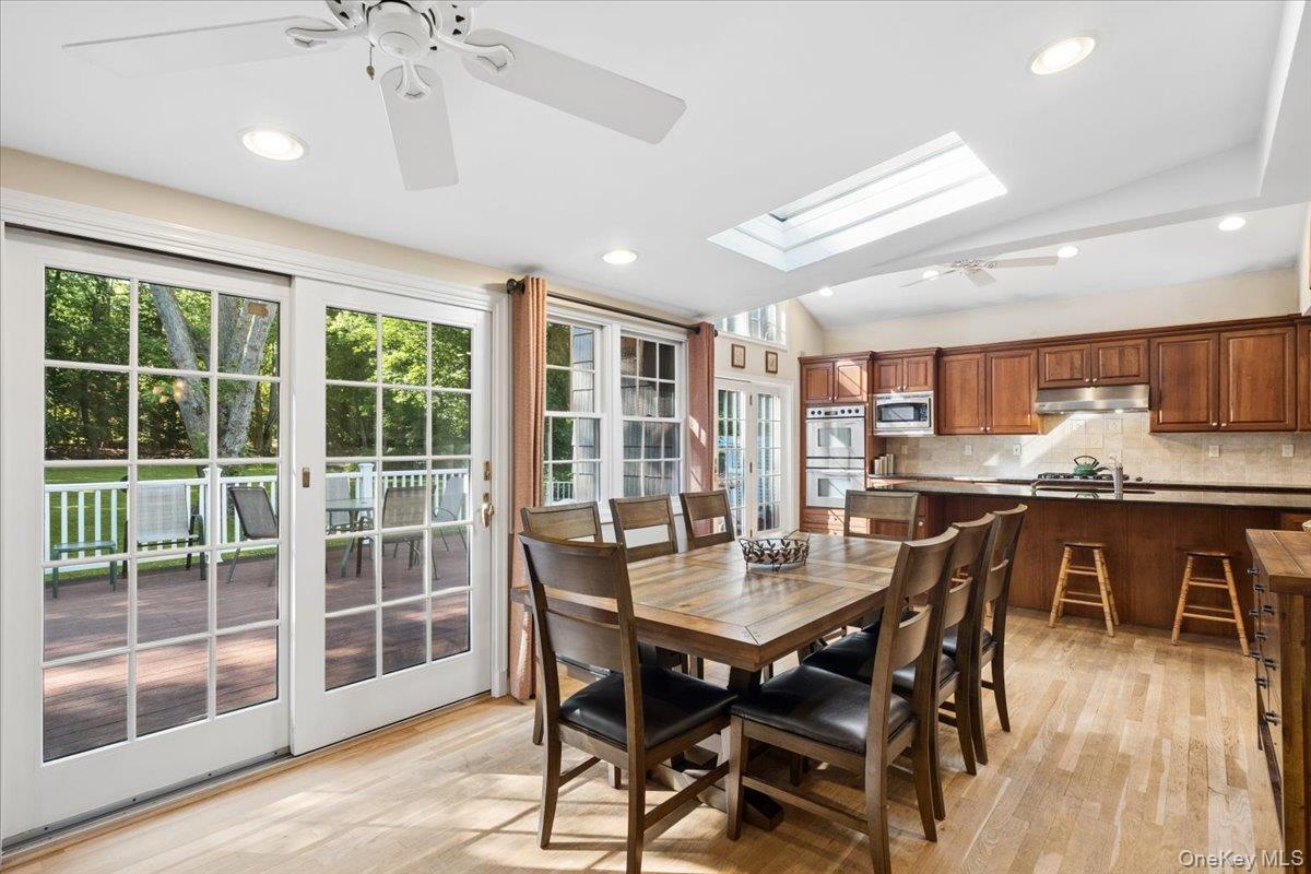 372 Fort Hill Road Scarsdale, NY 10583 - Photo 11 of 40 Enjoy dining in the kitchen/family room with views out to the deck and beautifully landscaped property