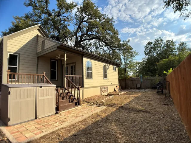 a backyard of a house with table and chairs